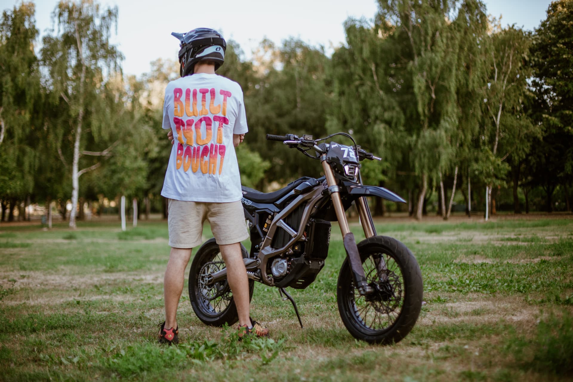 Built Not Bought Tee Sunset — rider with bike